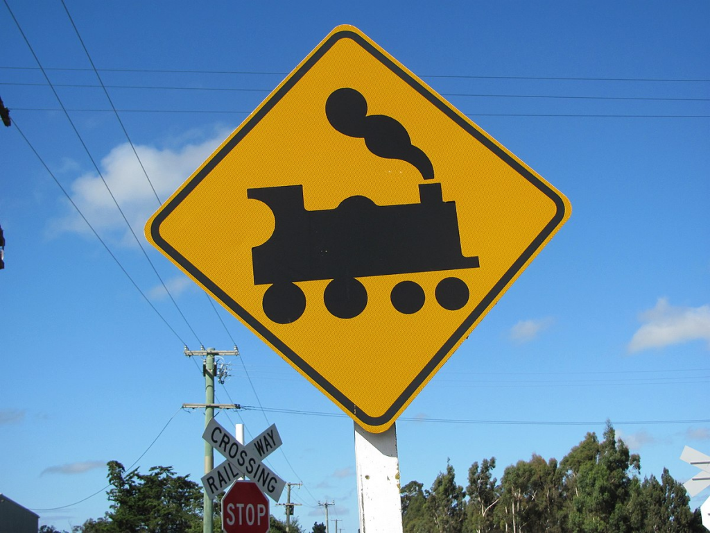 Road sign depicting a 4-4-0 steam locomotive. In many countries this symbol is used to indicate a railway crossing, an example of skeuomorph design as steam locomotives are relatively rare these days.